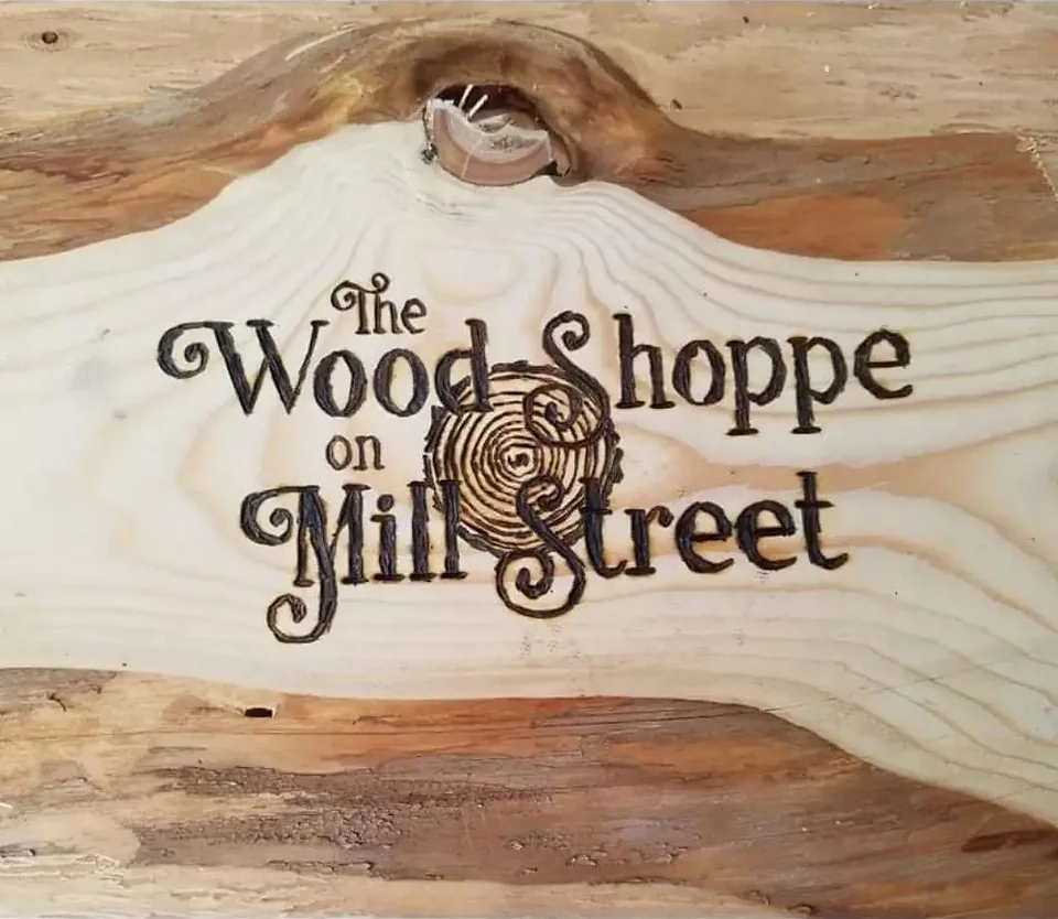 The Wood Shoppe on Mill Street logo wood-burned into a pine board